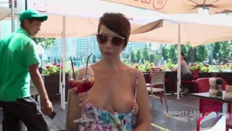 Short-haired MILF shows her boobs in public